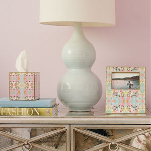 colorful photo frame and tissue box cover on table